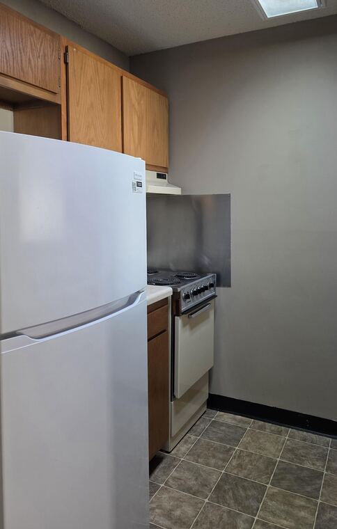 Kitchen with refrigerator and range
